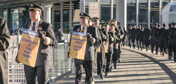 a group of people in uniform holding signs