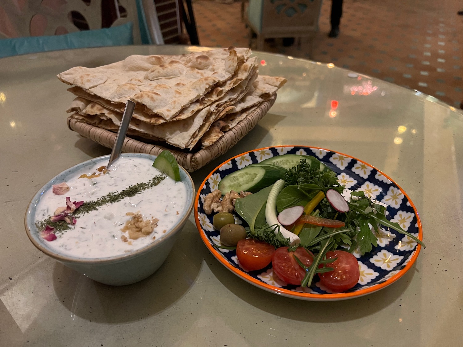 a plate of food and a bowl of salad on a table