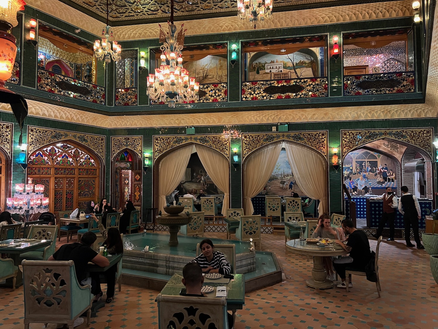 a group of people sitting at tables in a restaurant