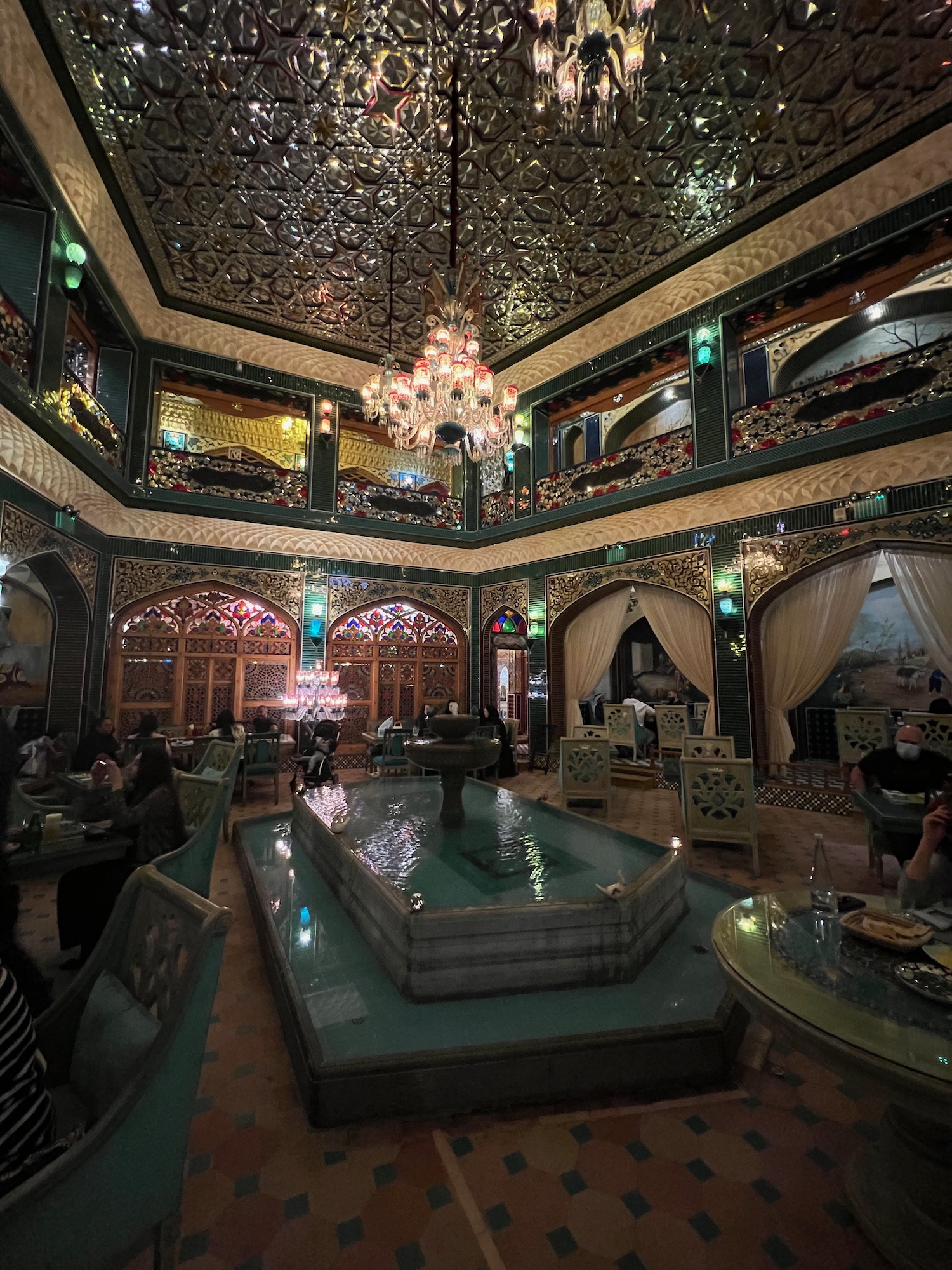 a room with a fountain and a chandelier