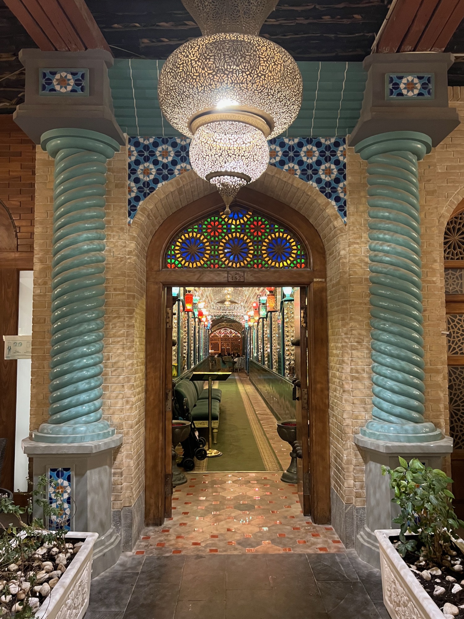 a hallway with colorful columns and a light fixture