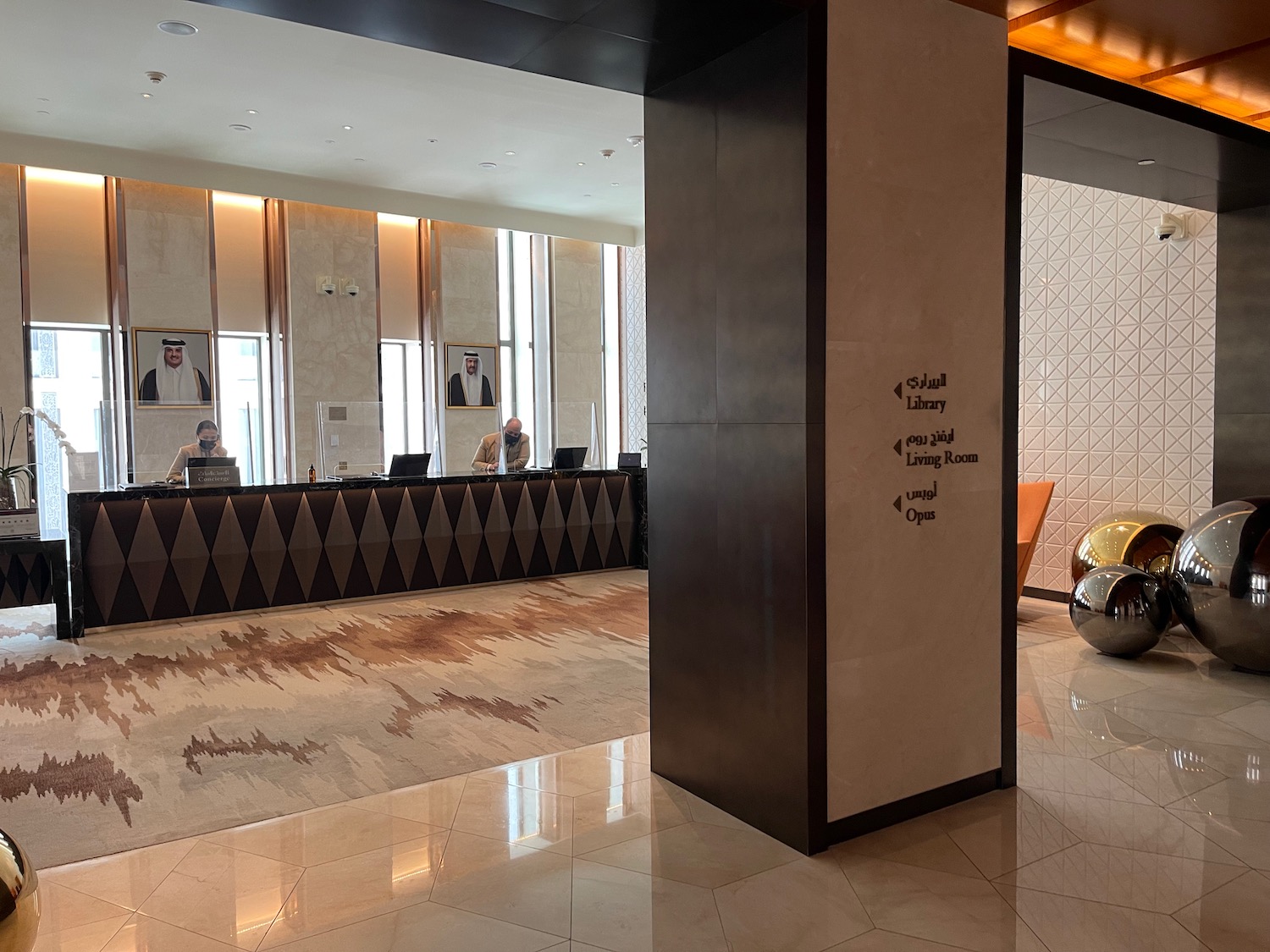 a lobby with a reception desk and people sitting at the counter