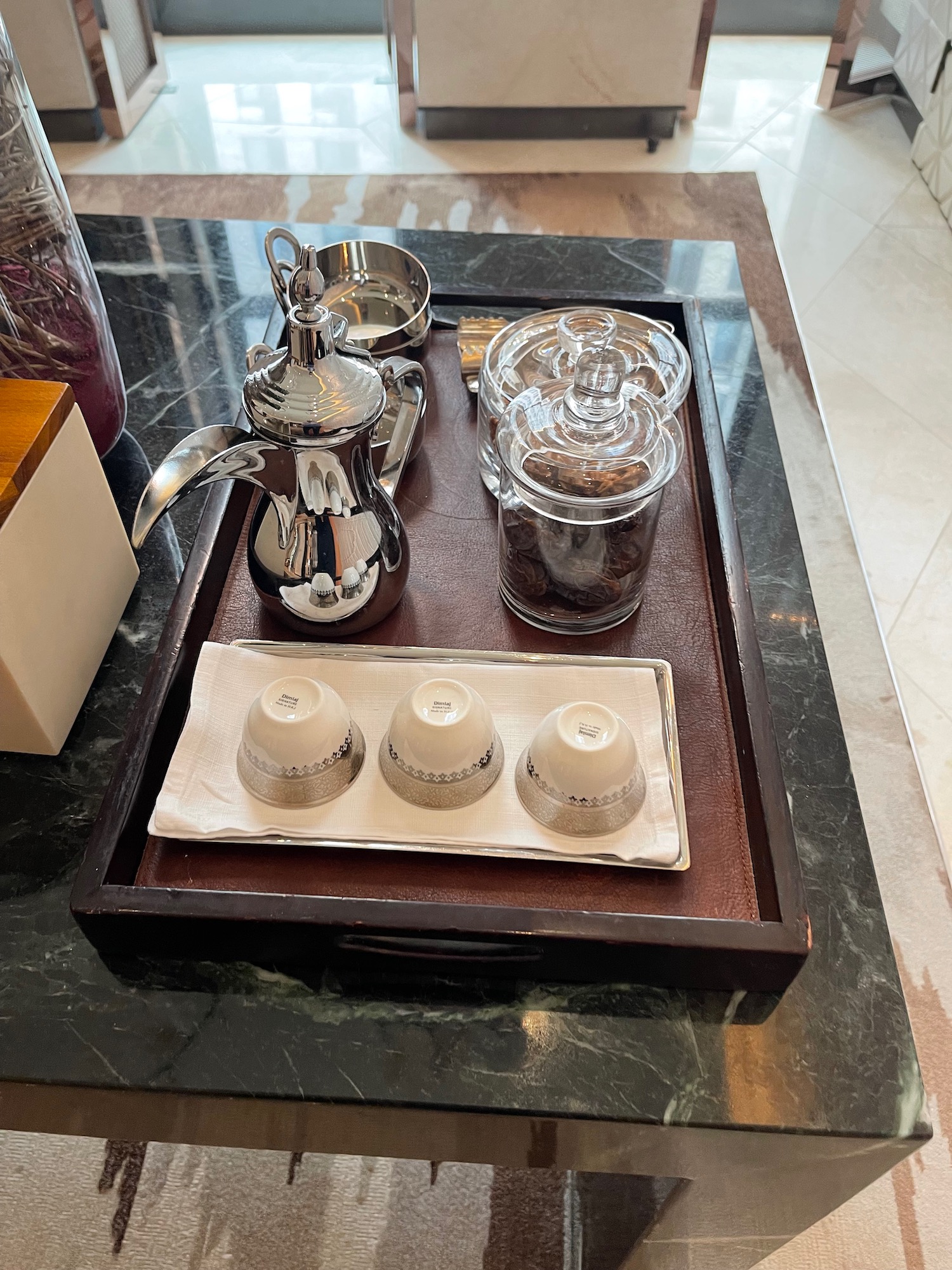 a tray with coffee pot and cups on it