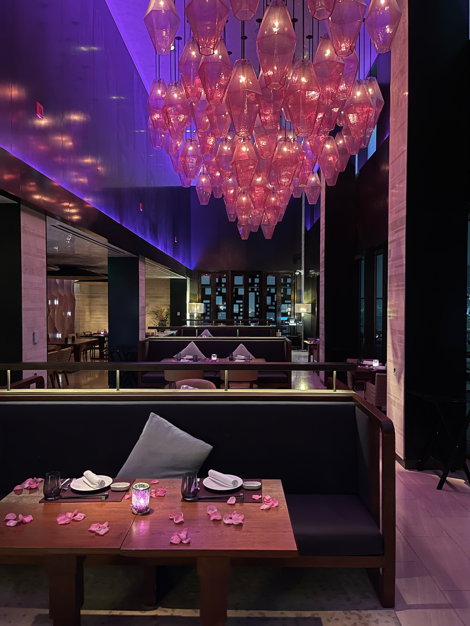 a restaurant with a chandelier and tables