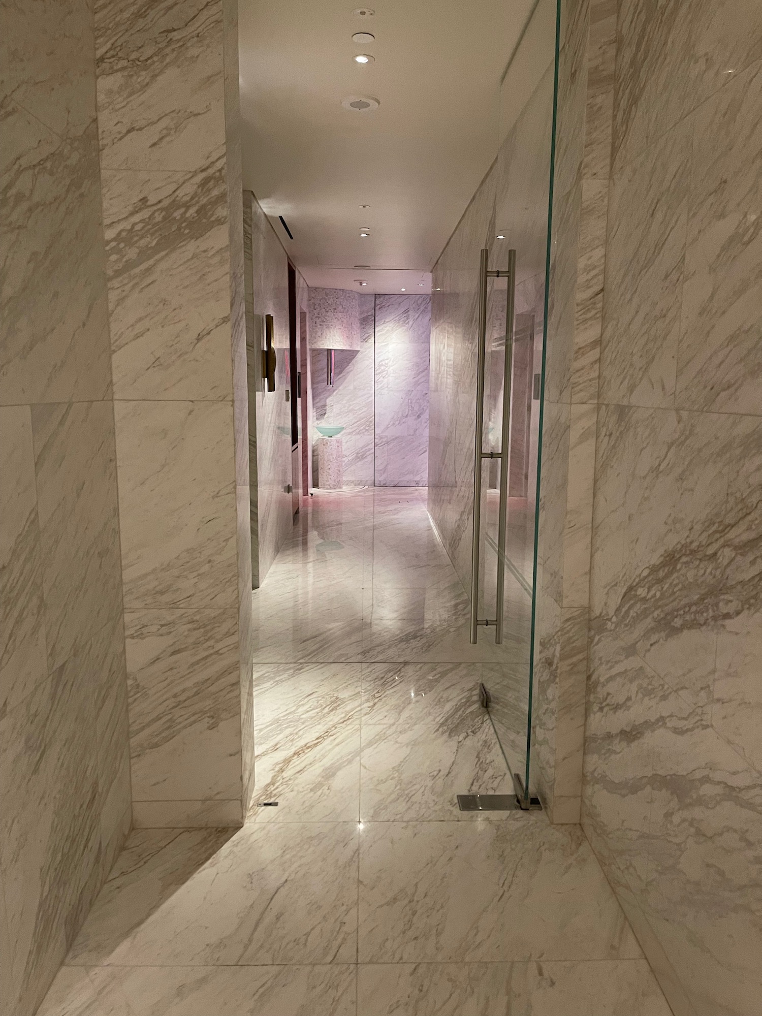 a marble hallway with glass doors