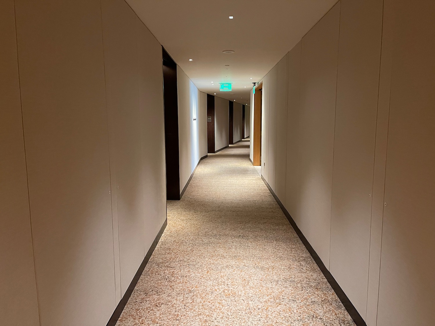 a long hallway with a light on the wall