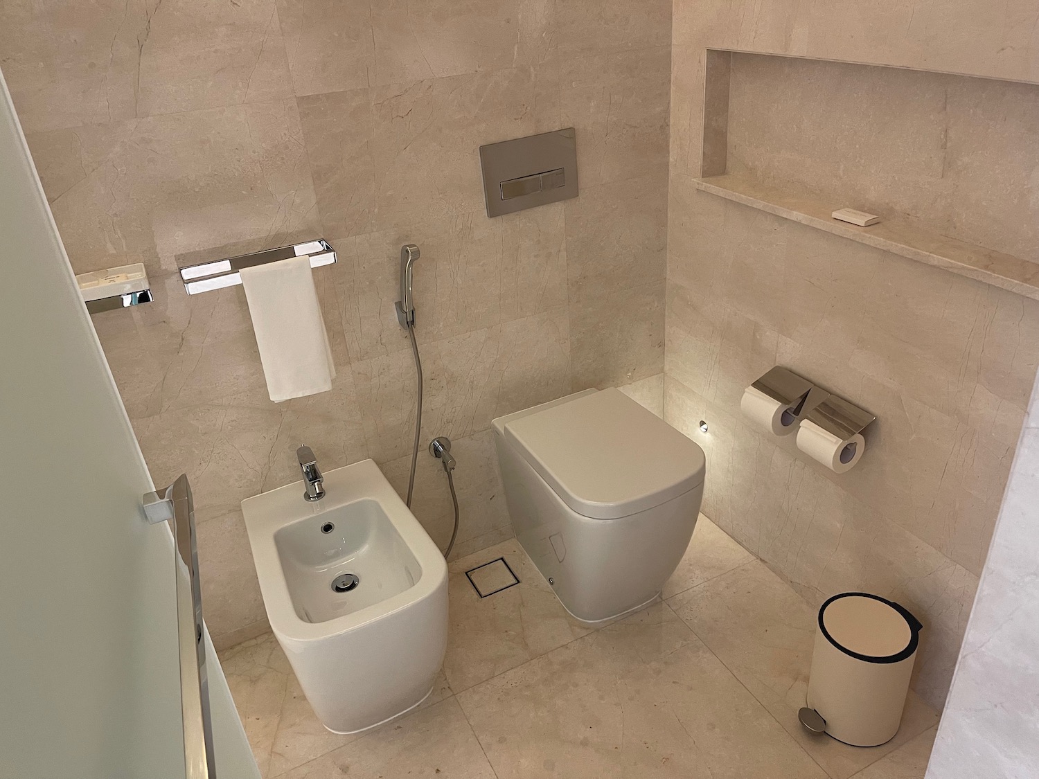 a bathroom with a toilet and a bidet