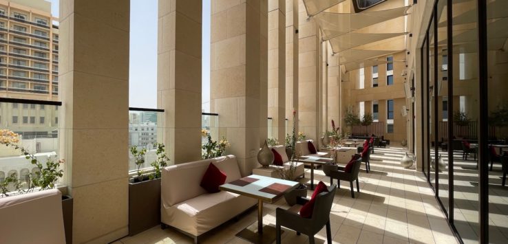 a patio with tables and chairs