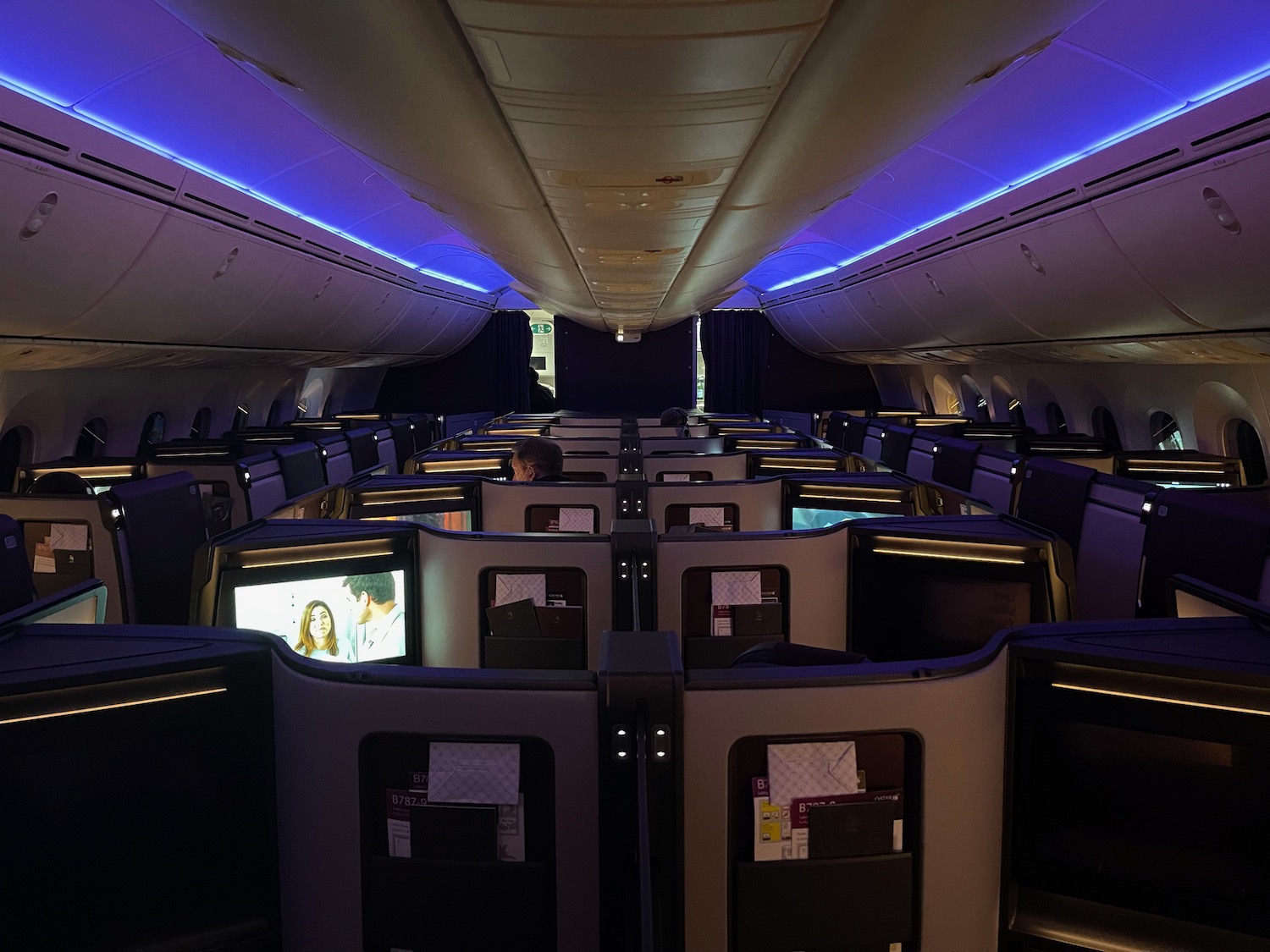 an airplane with rows of seats and monitors