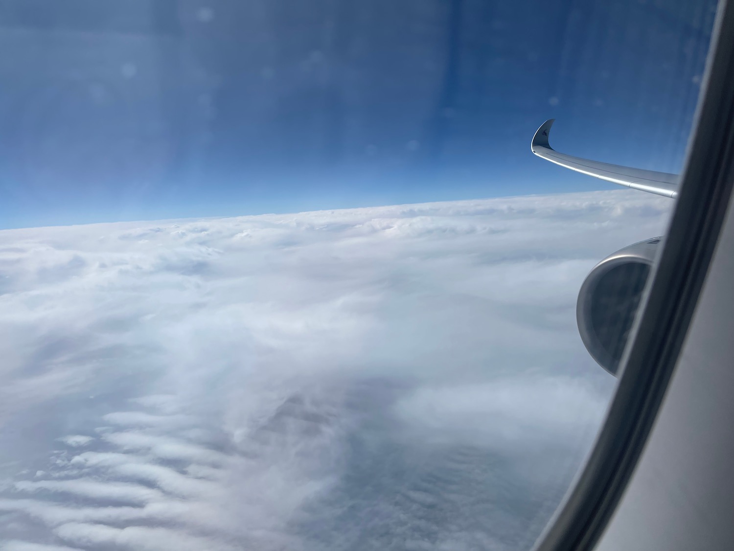 an airplane wing above the clouds