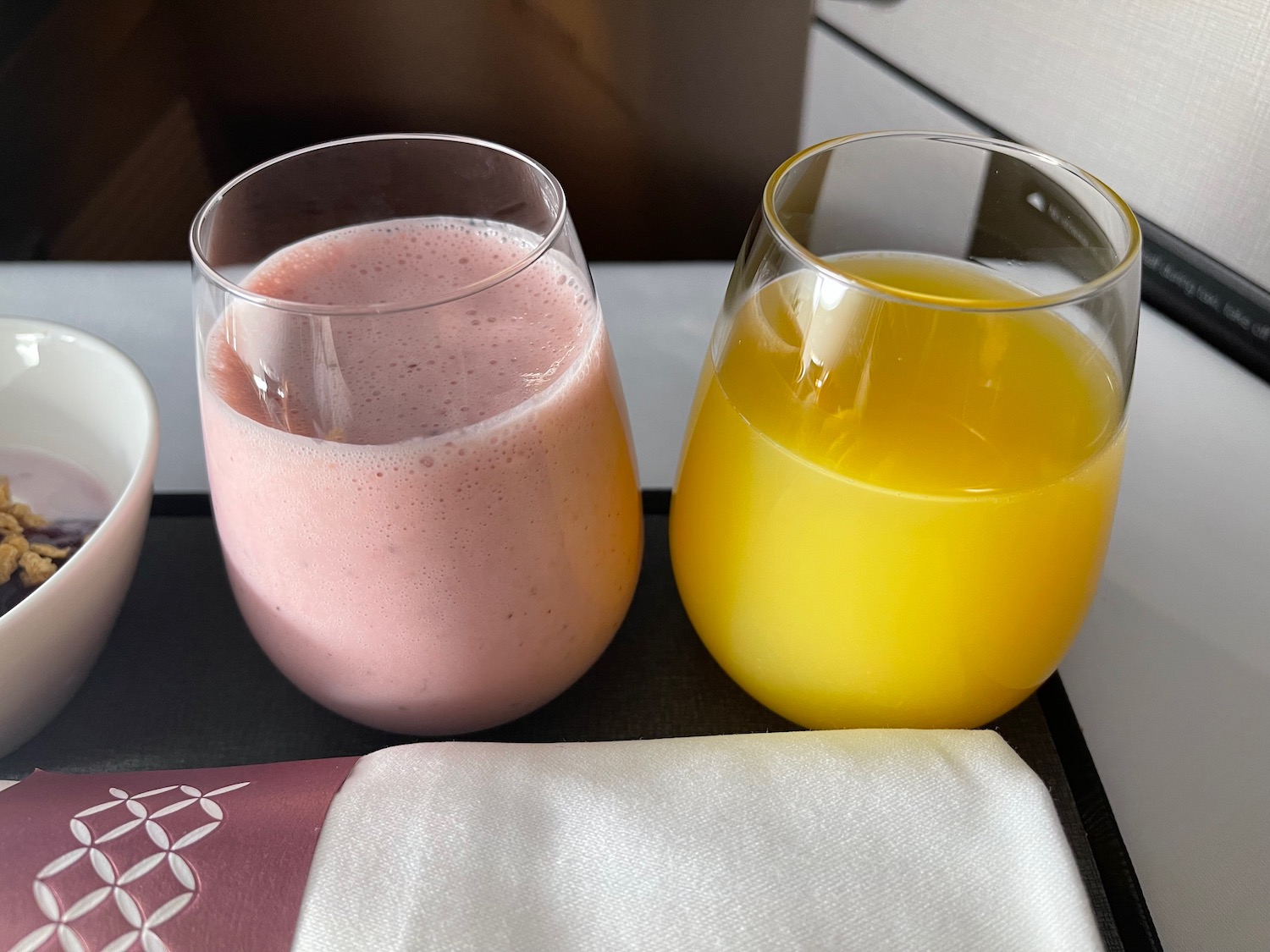two glasses of juice and a napkin