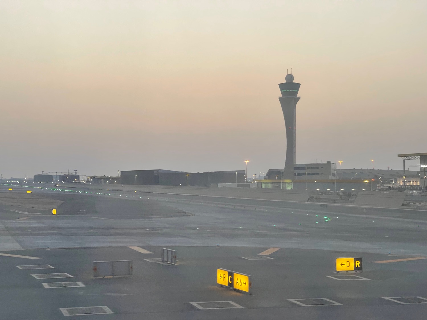 a runway with a tower in the background