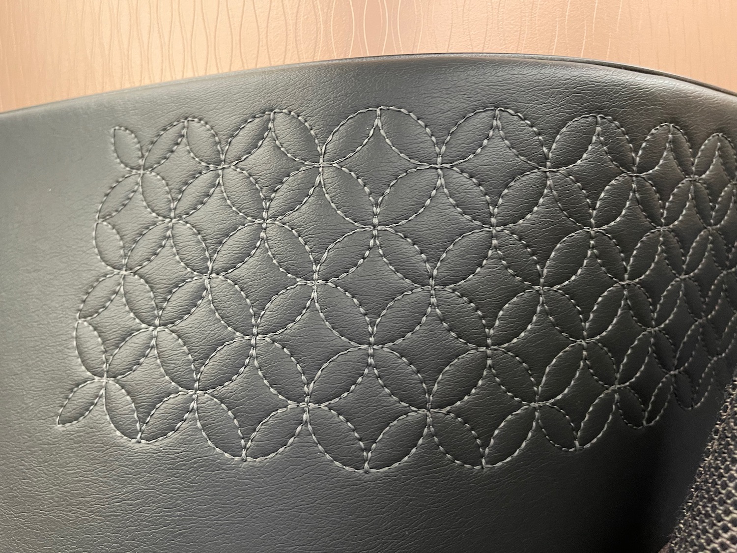 a black leather chair with a pattern on it