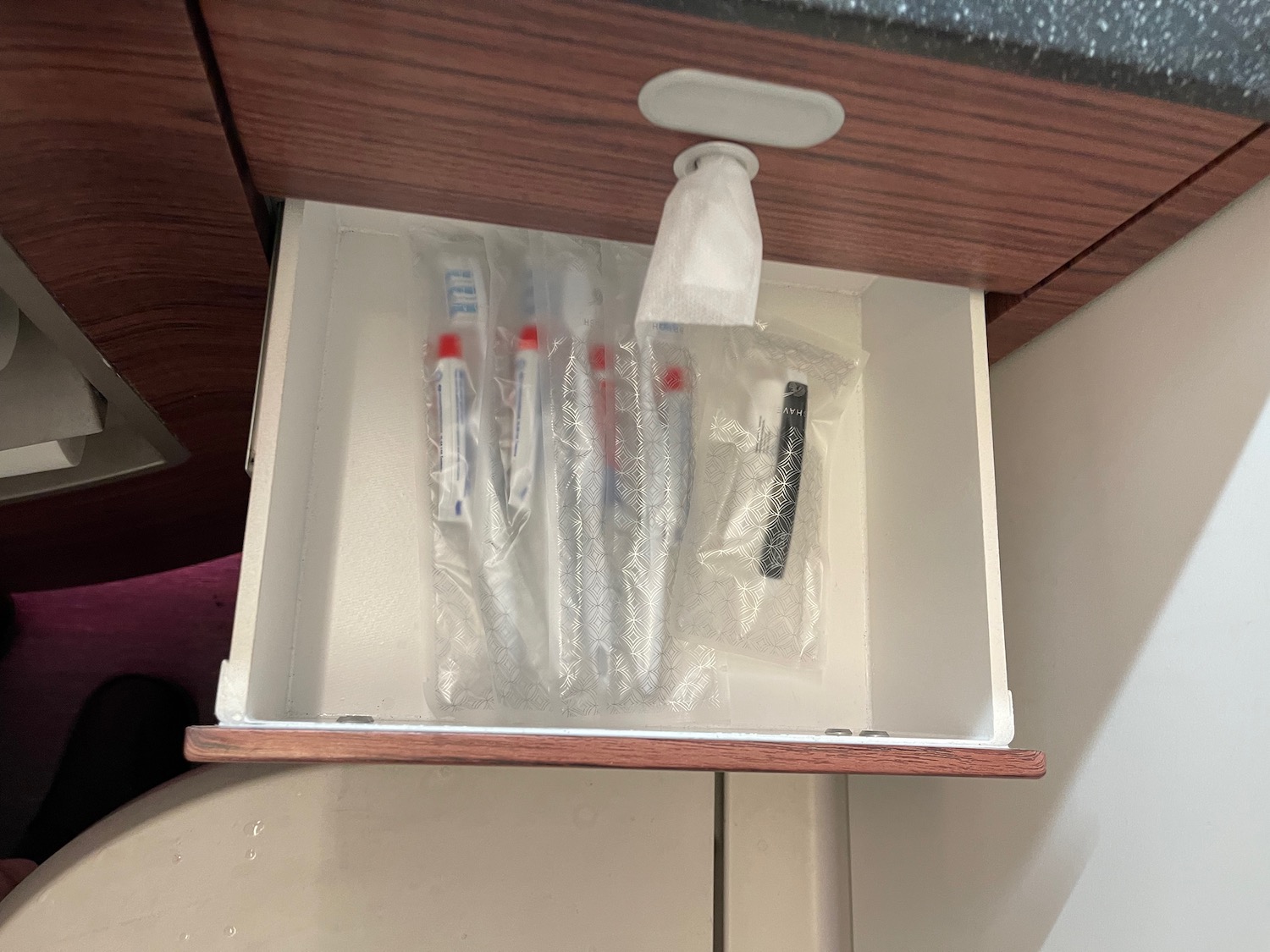a drawer with a few toothbrushes in it