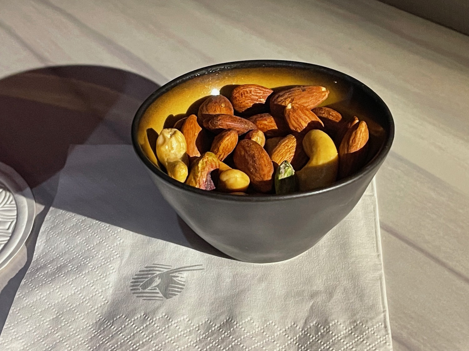 a bowl of nuts on a napkin