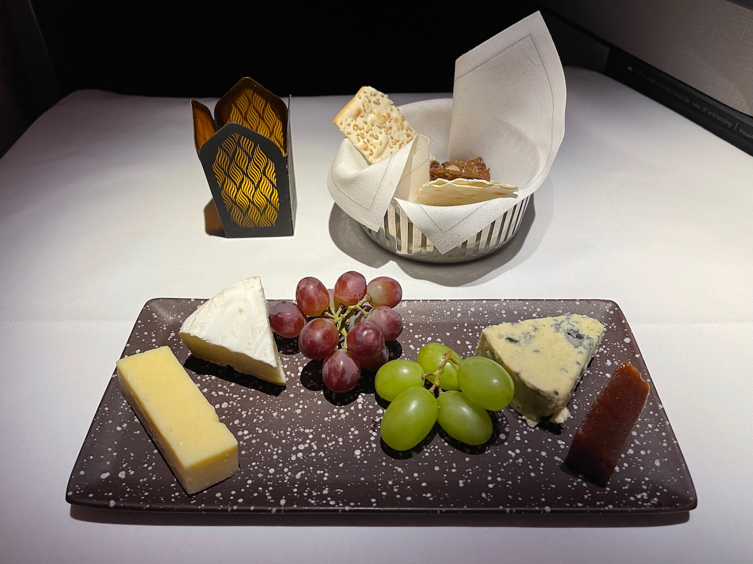 a plate of cheese and grapes