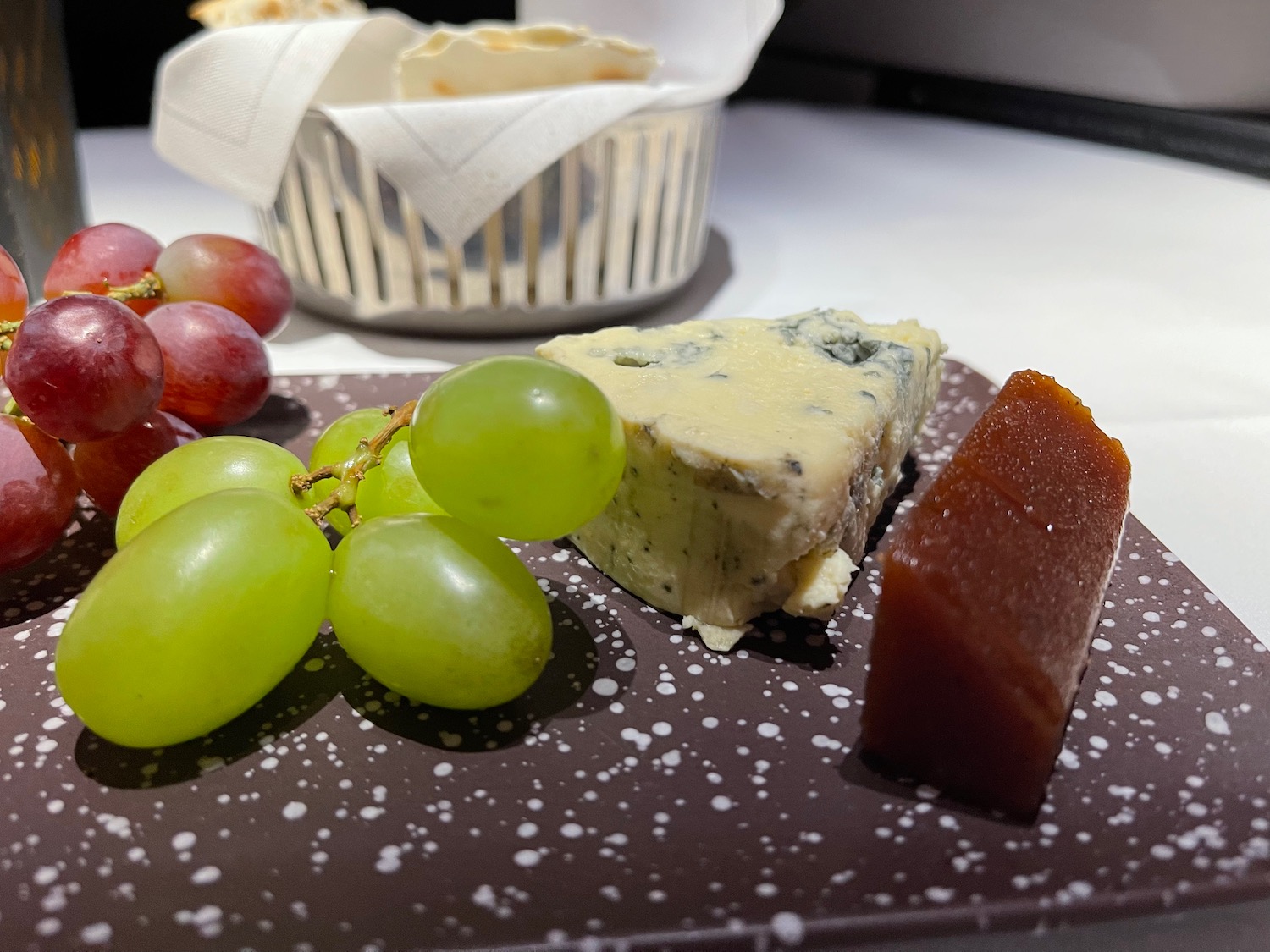 a plate of food with grapes and cheese