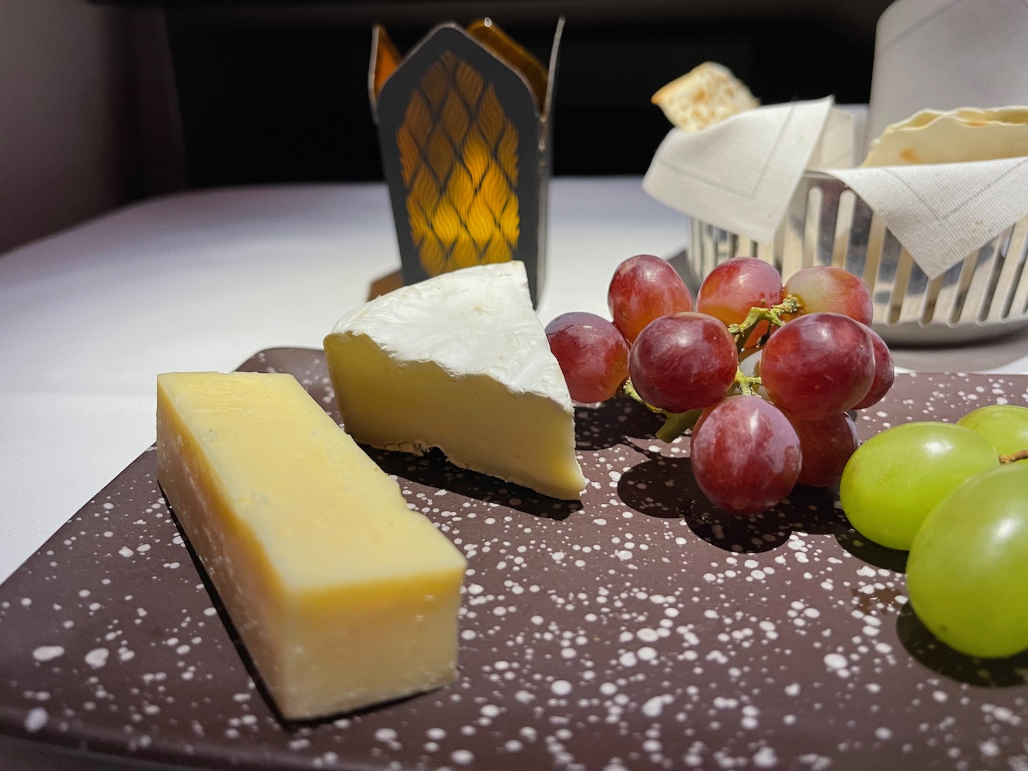 a plate of cheese and grapes