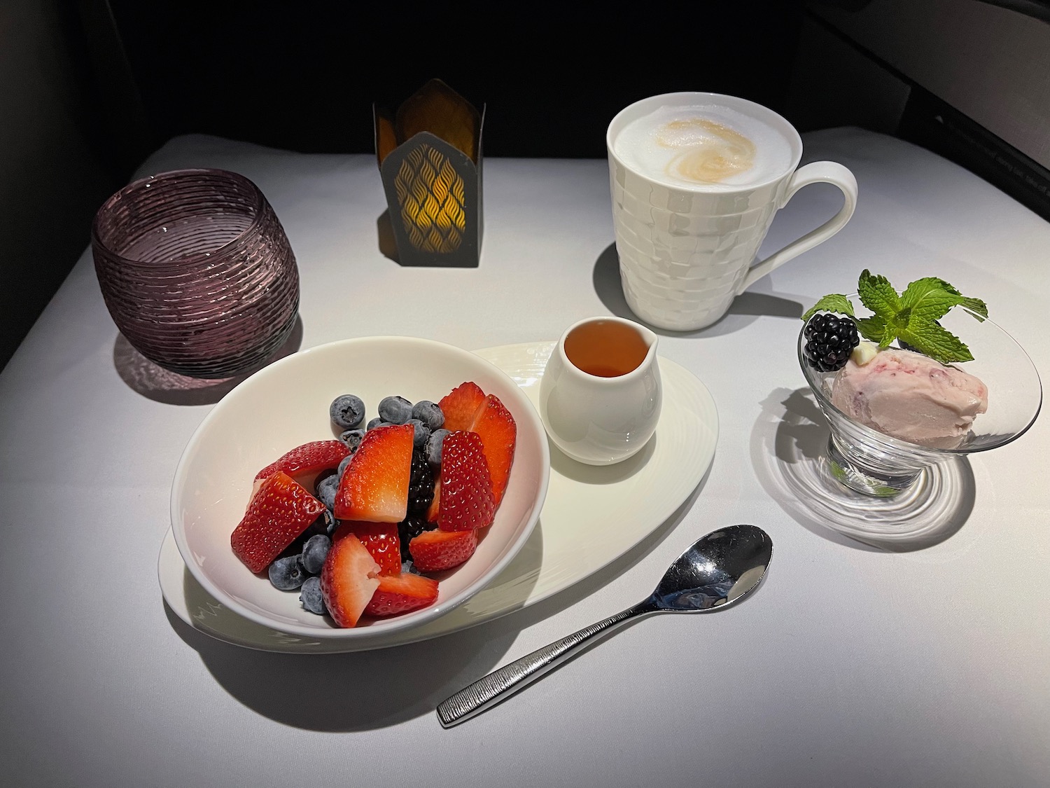 a plate of fruit and a cup of coffee