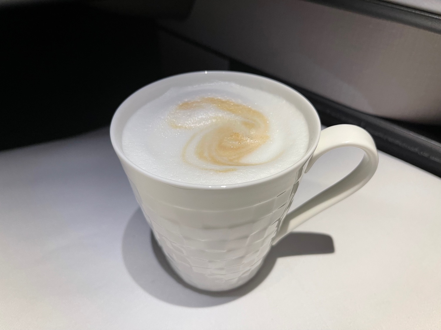 a white cup with foam in it