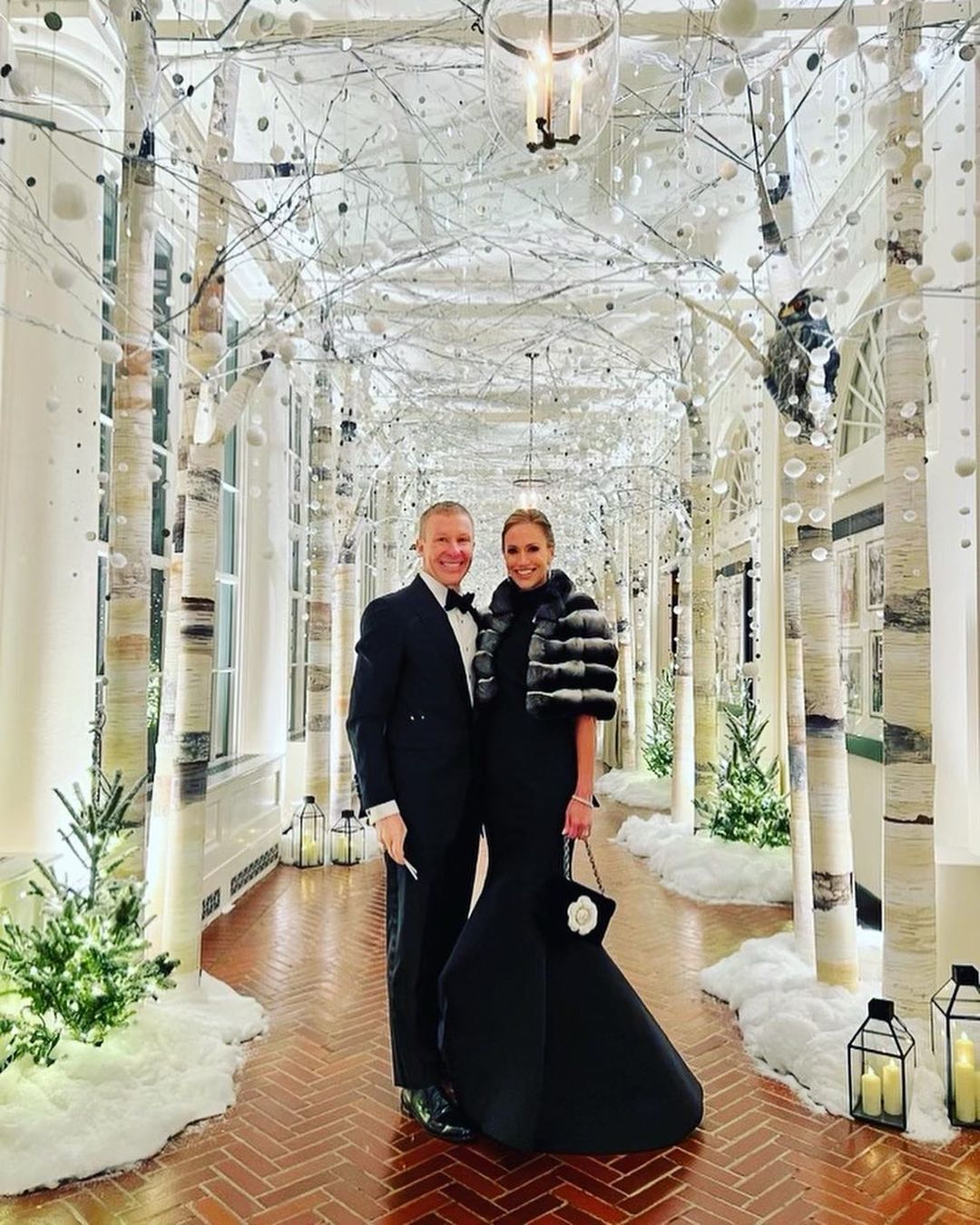 a man and woman standing in a hallway