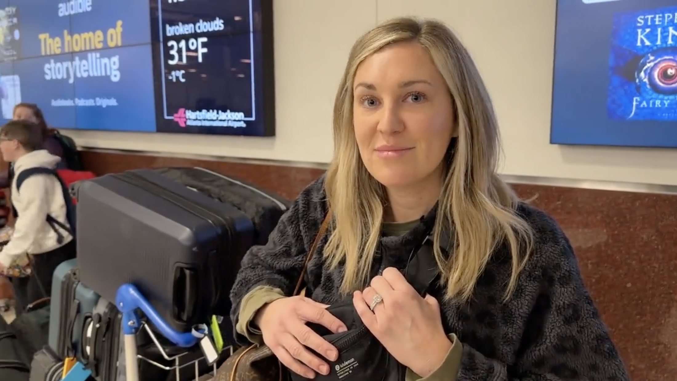 a woman holding a black bag