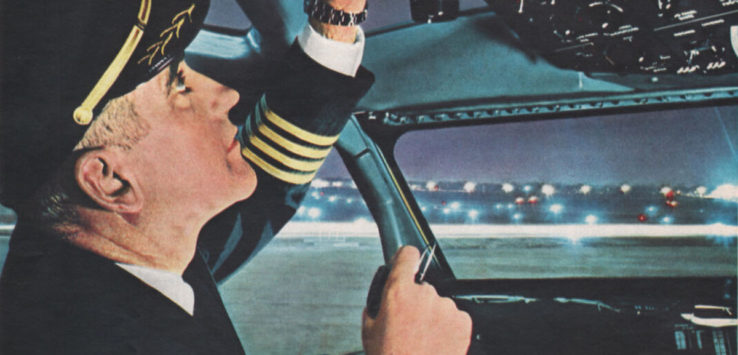 a man in a pilot's uniform in a cockpit