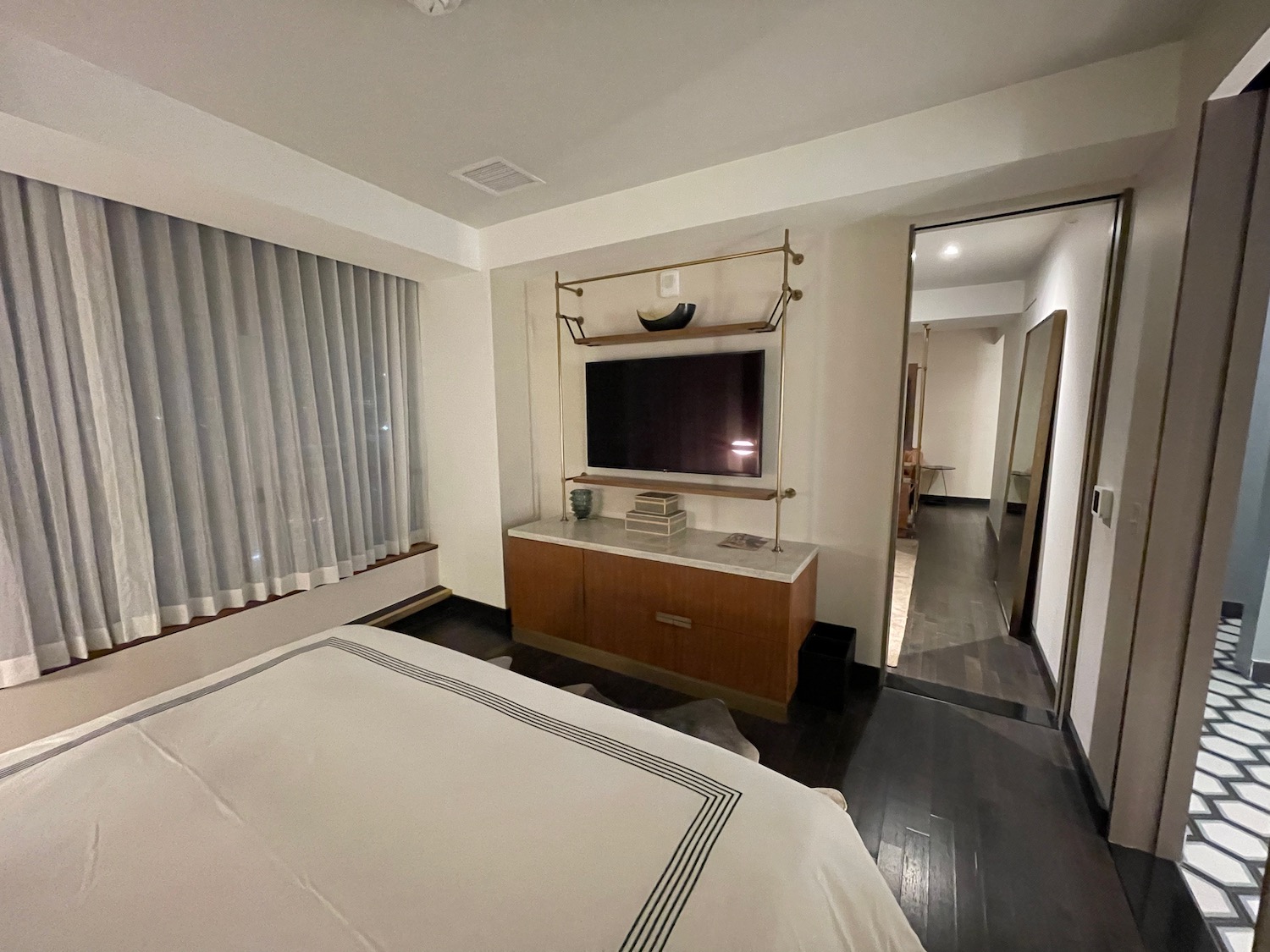 a bedroom with a tv and a bed