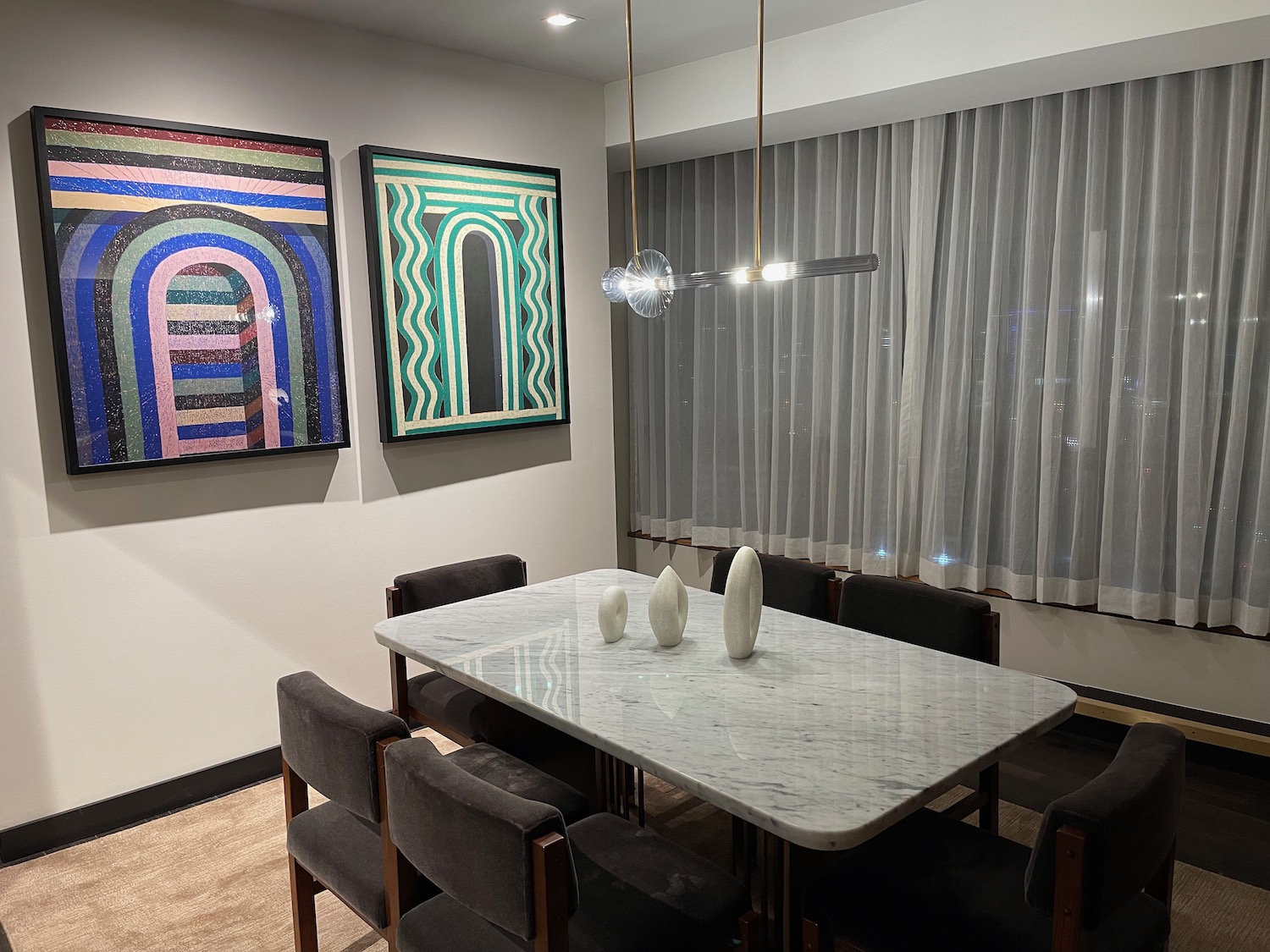 a table with chairs and art on the wall