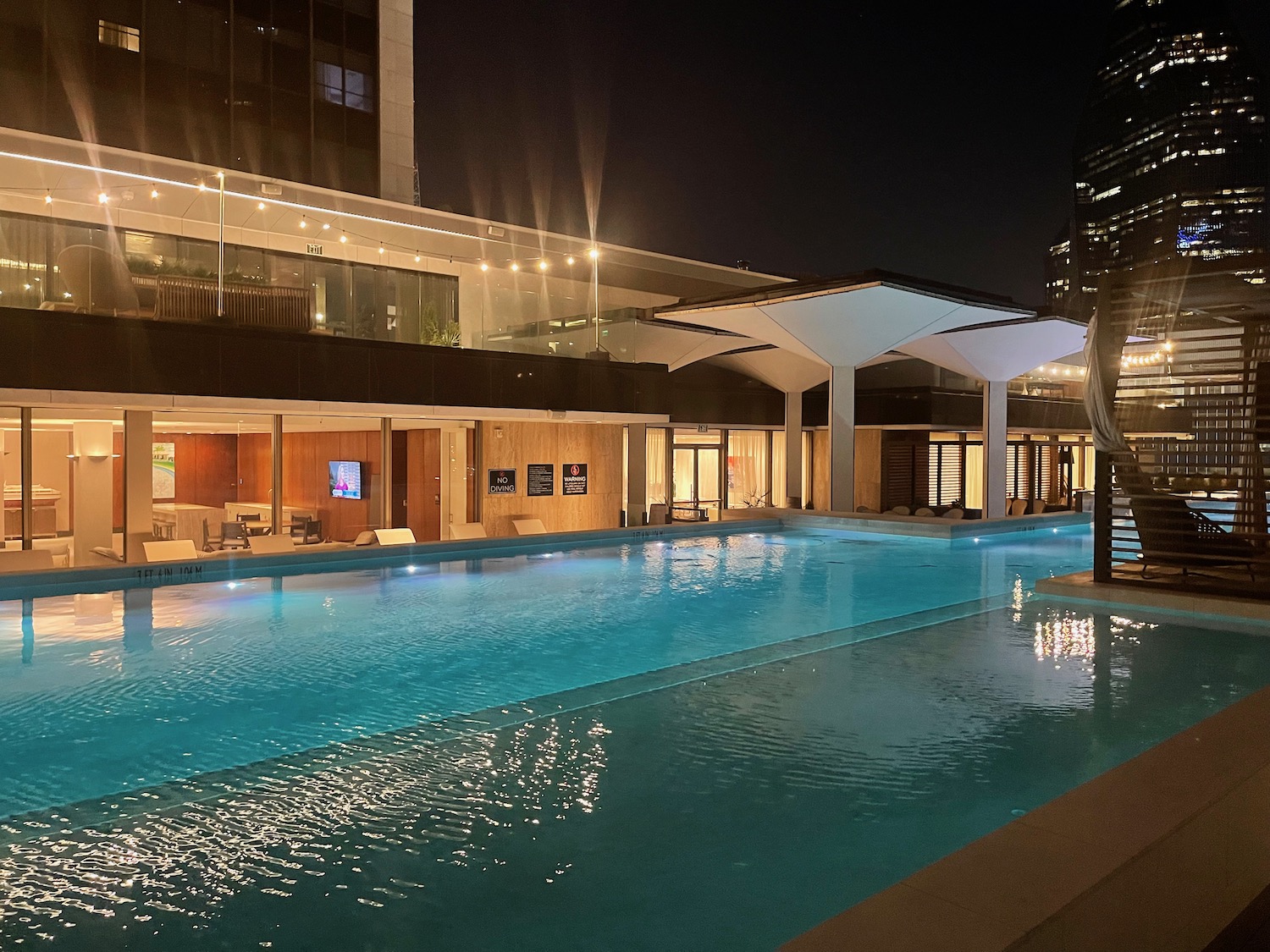 a swimming pool with a building in the background