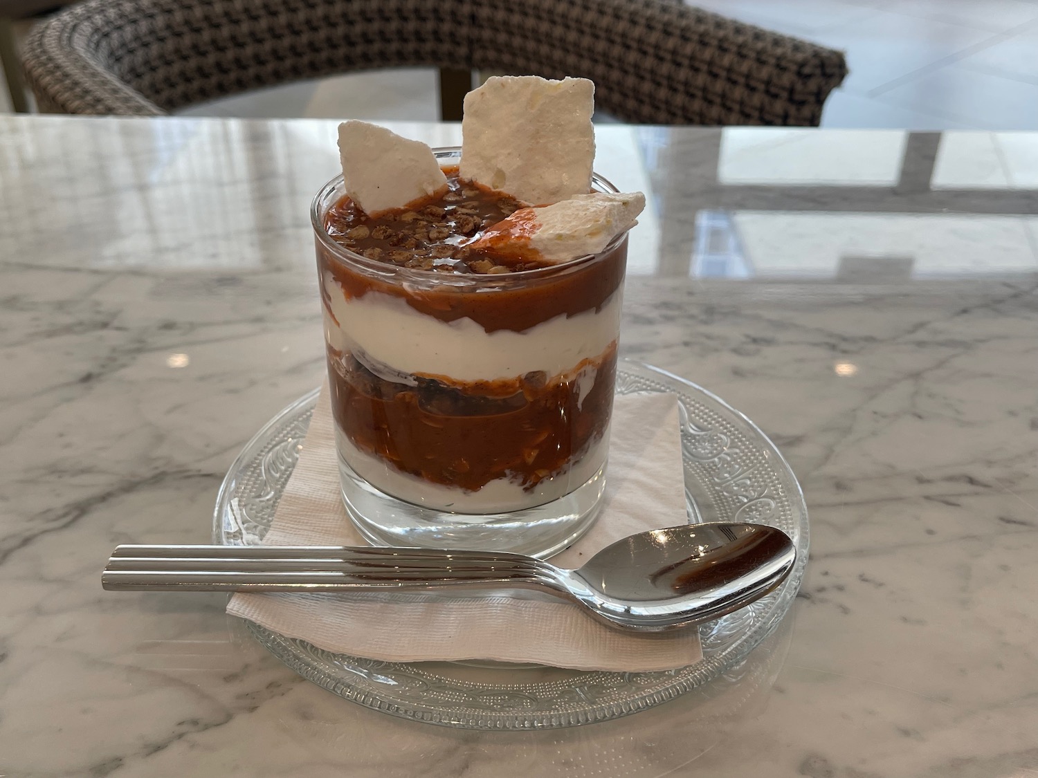 a dessert in a glass cup with a spoon