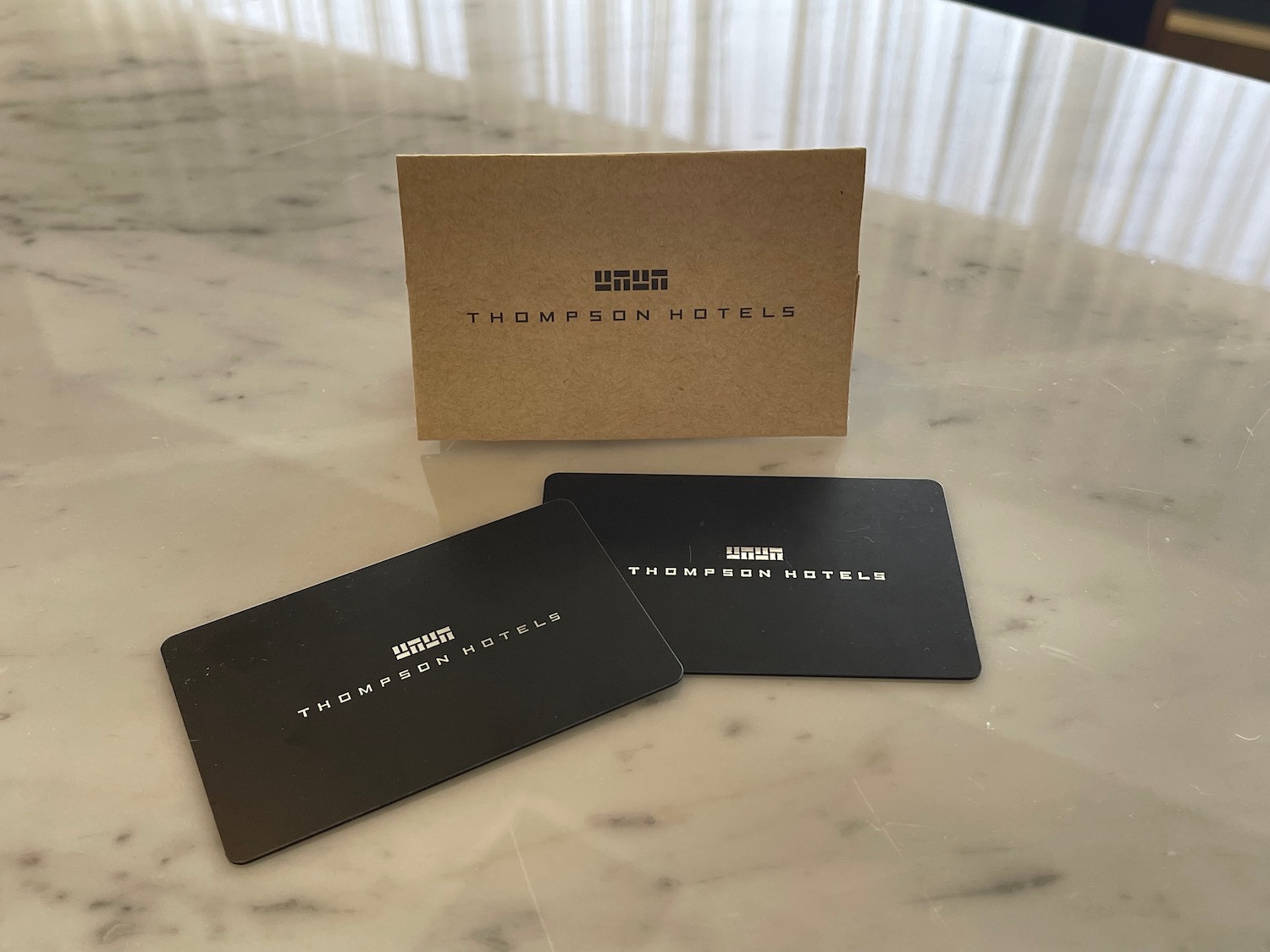 a group of black business cards on a marble table