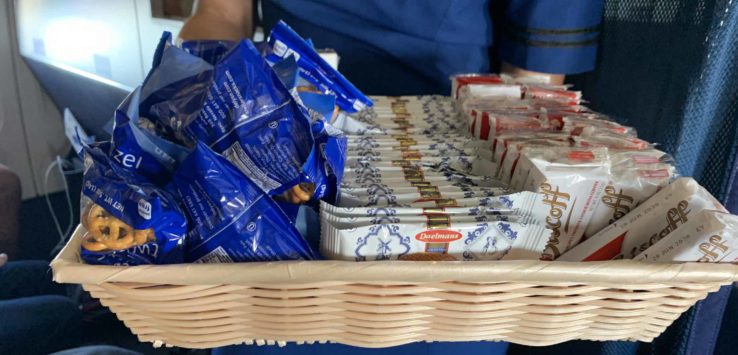 a basket of food in a person's hand