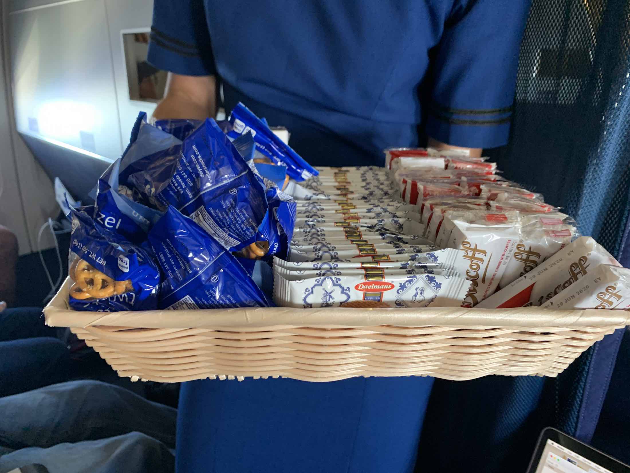 a basket of food in a person's hand