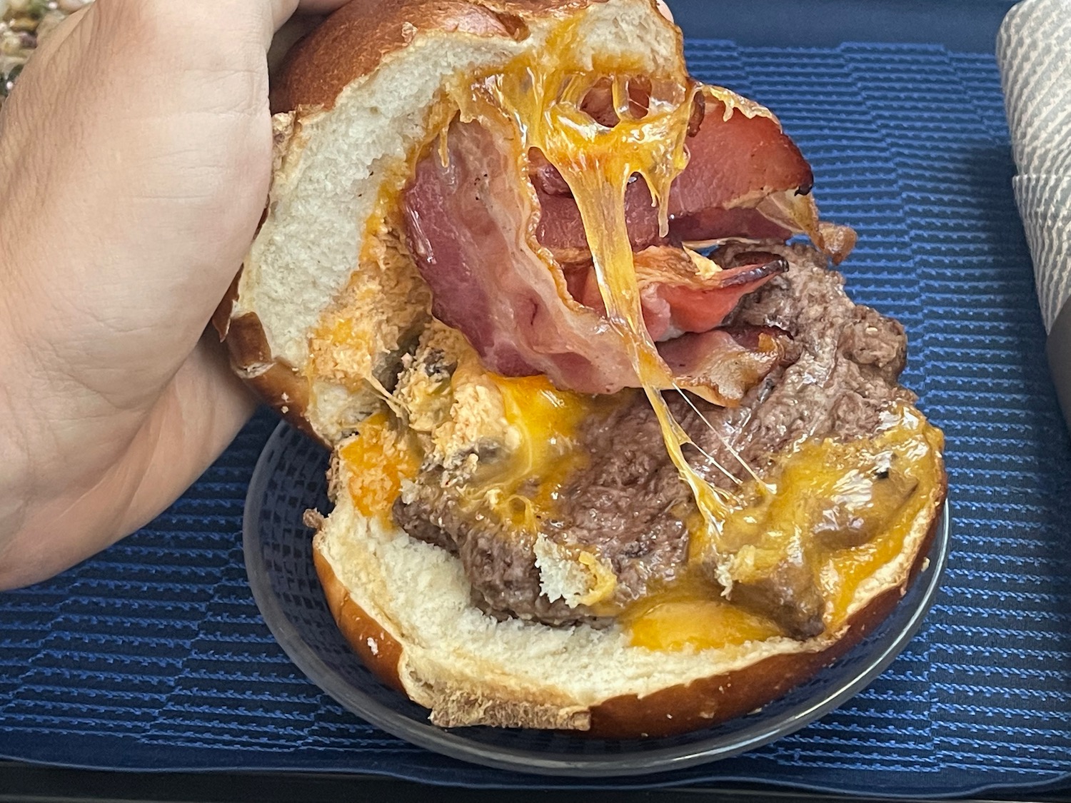 a burger with bacon and cheese on a plate