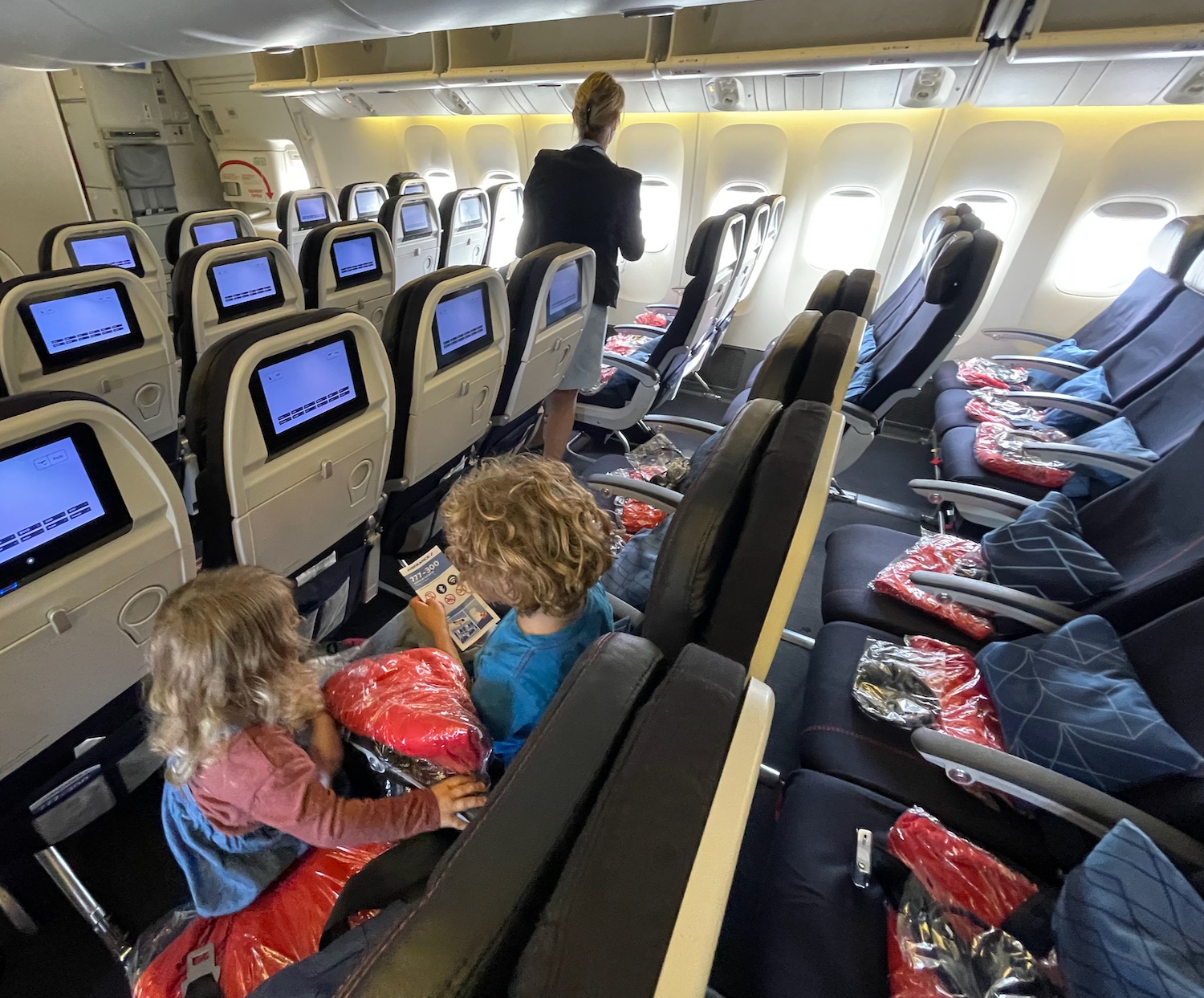 a group of children sitting in an airplane