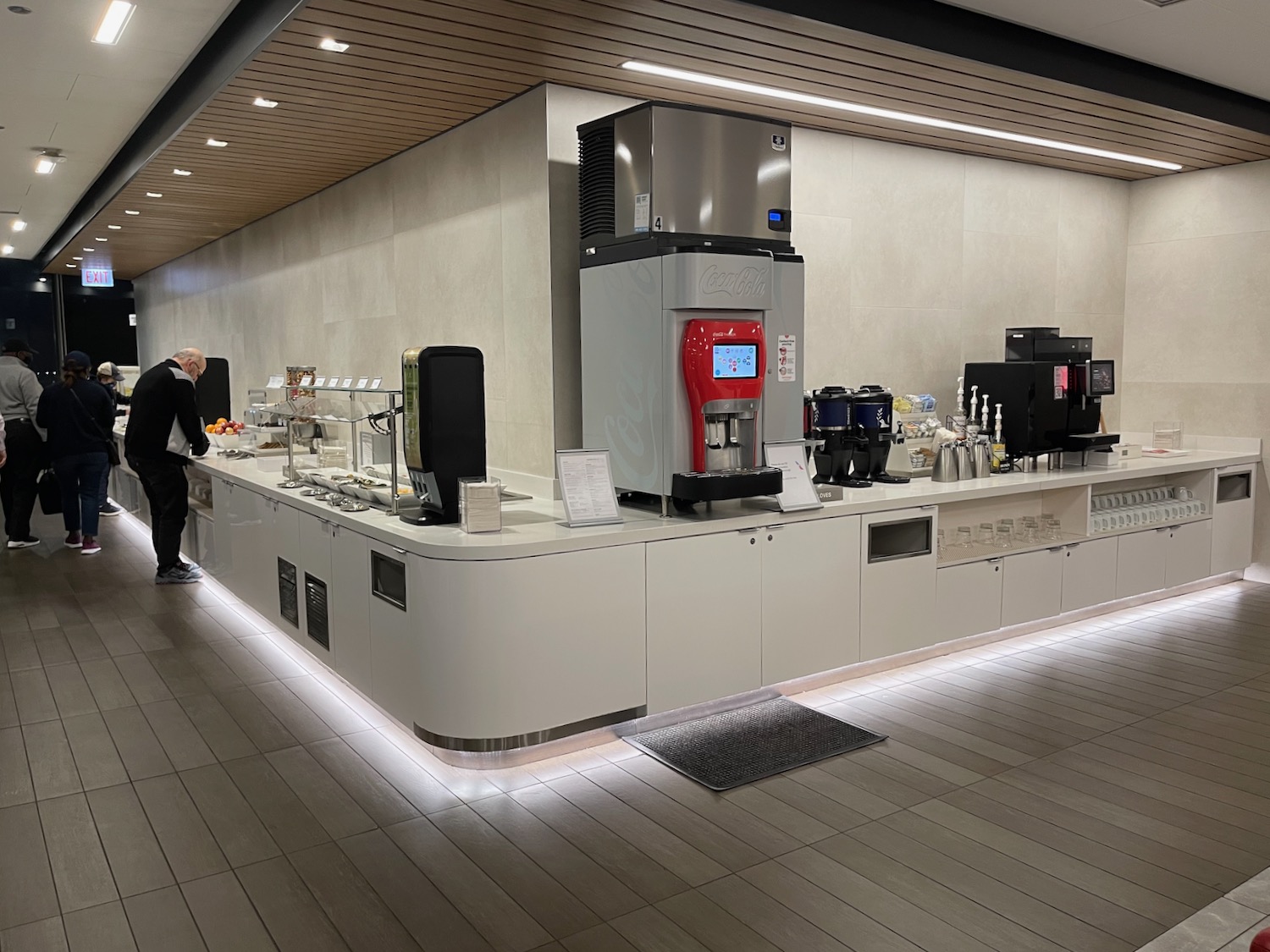 a man standing in front of a counter with a machine