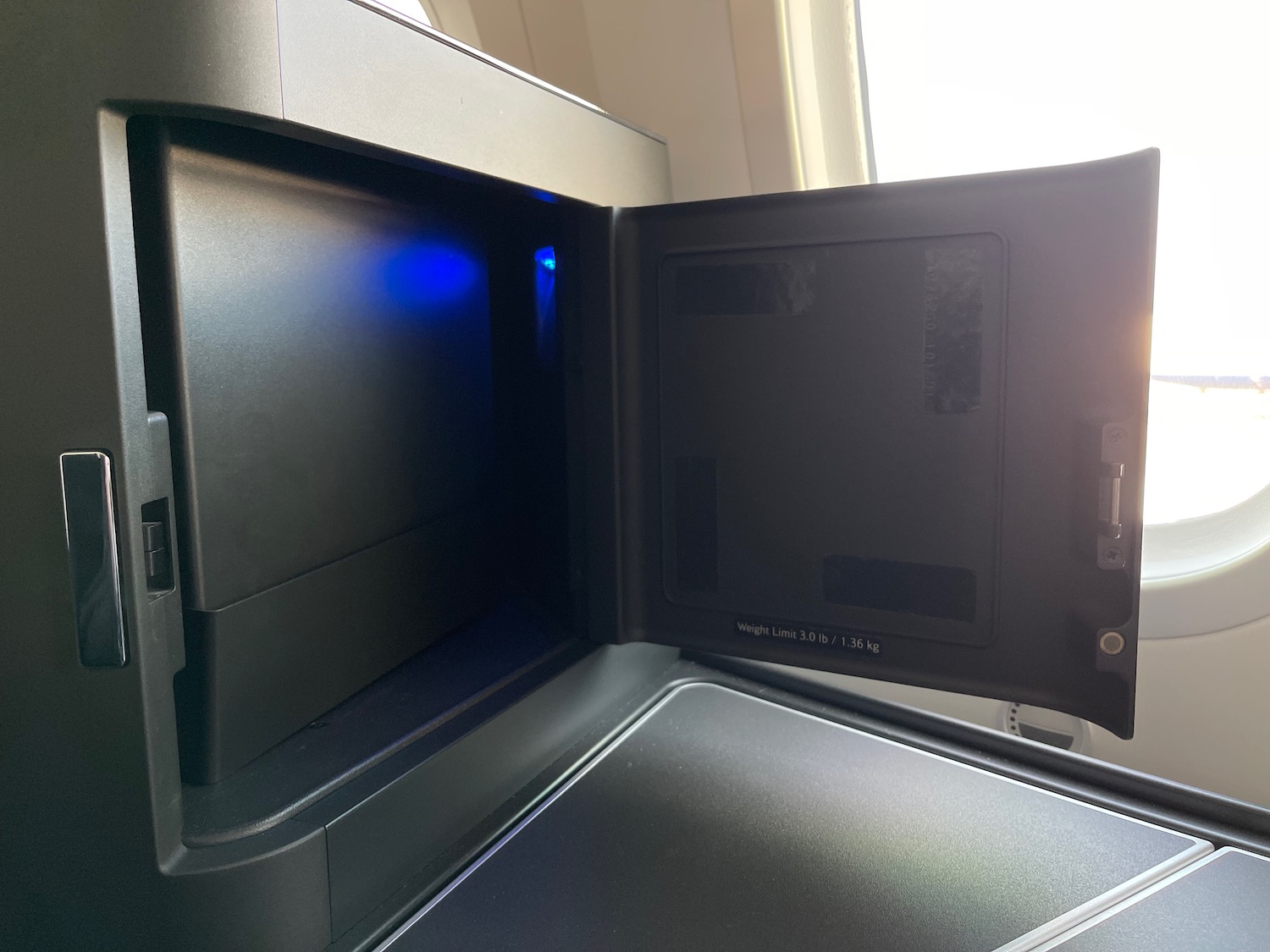 a black microwave with a blue light