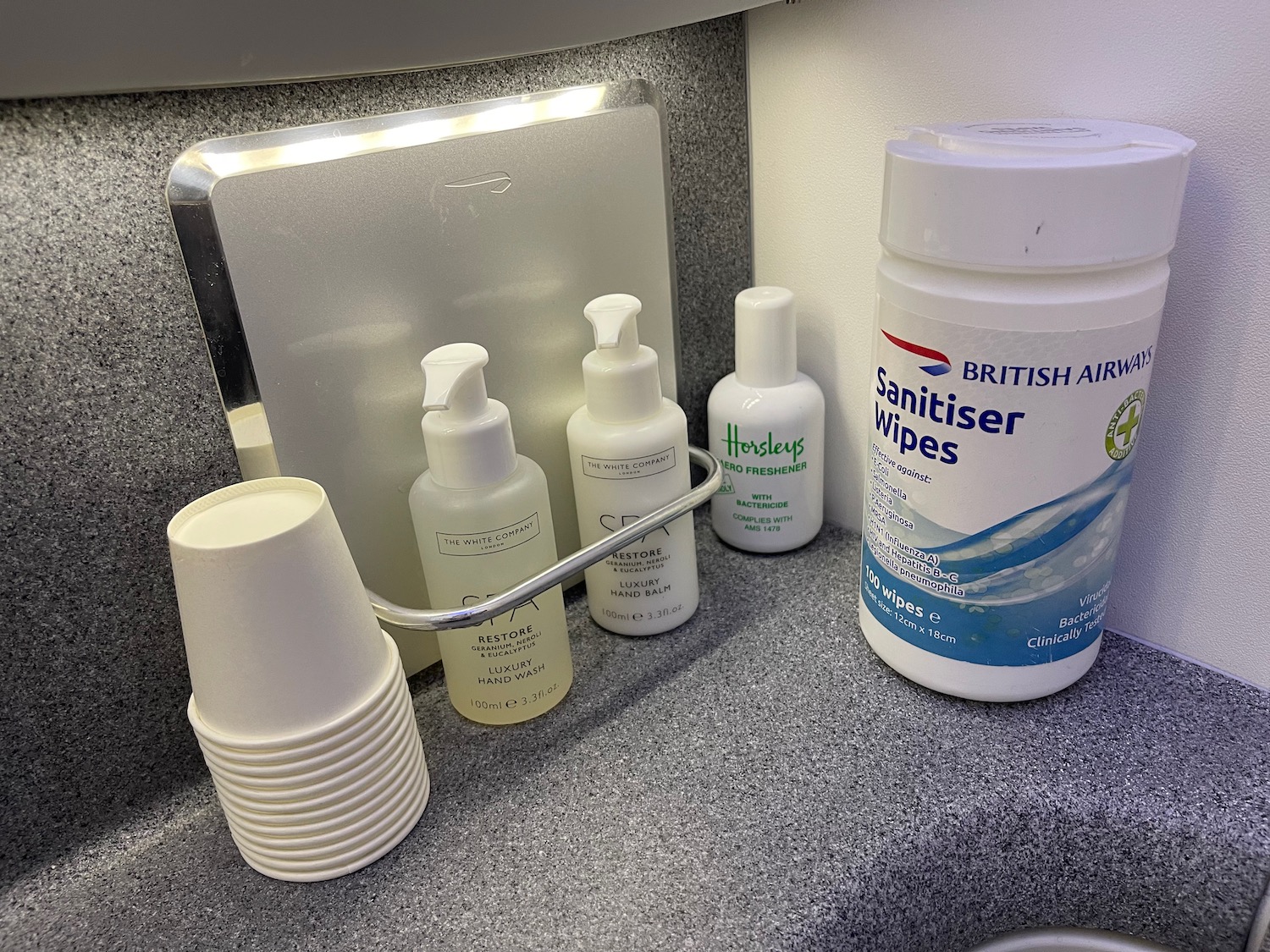 a group of white containers and cups on a counter