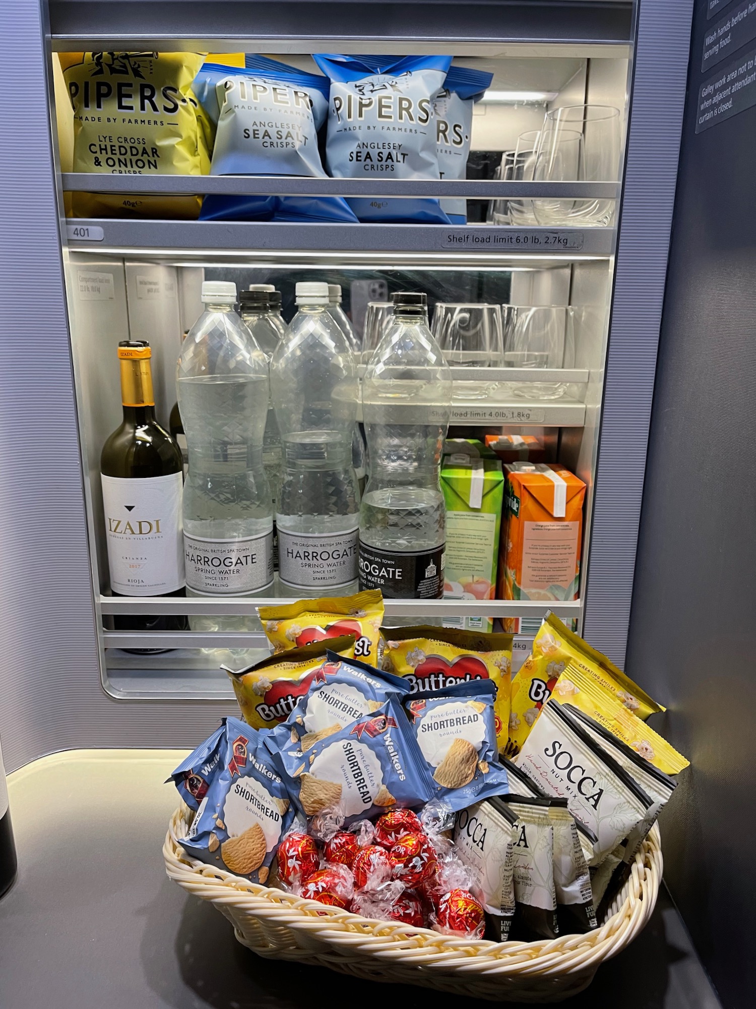 a basket of snacks and drinks in a refrigerator