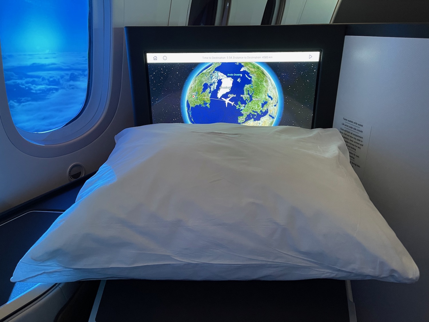 a pillow on a bed with a screen on it