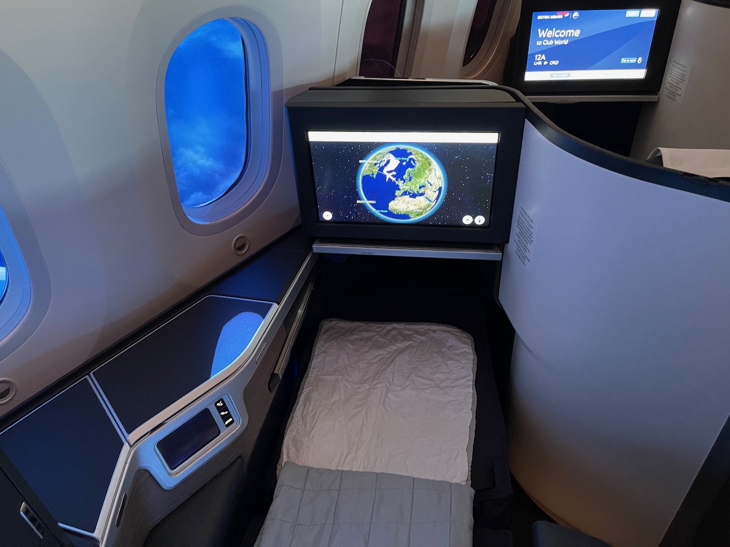 a bed in an airplane with a screen