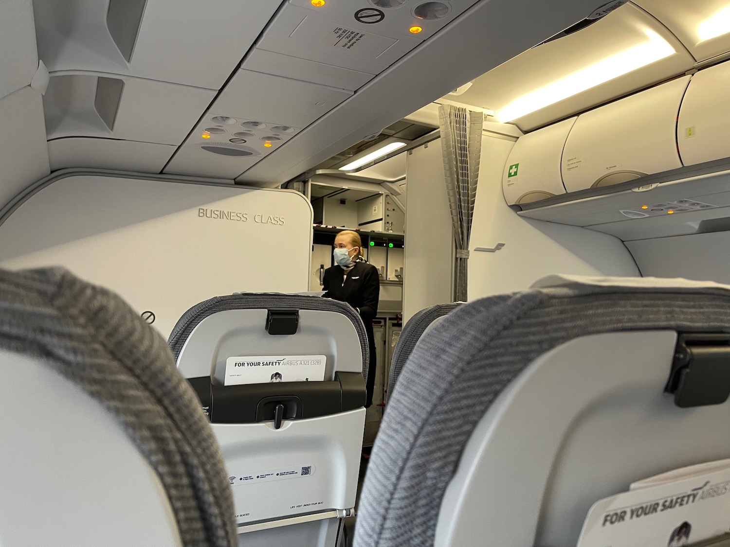 a person in a mask standing in an airplane