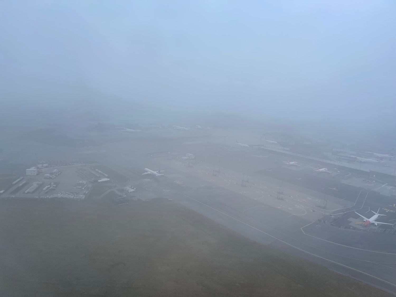 an aerial view of a runway in the fog