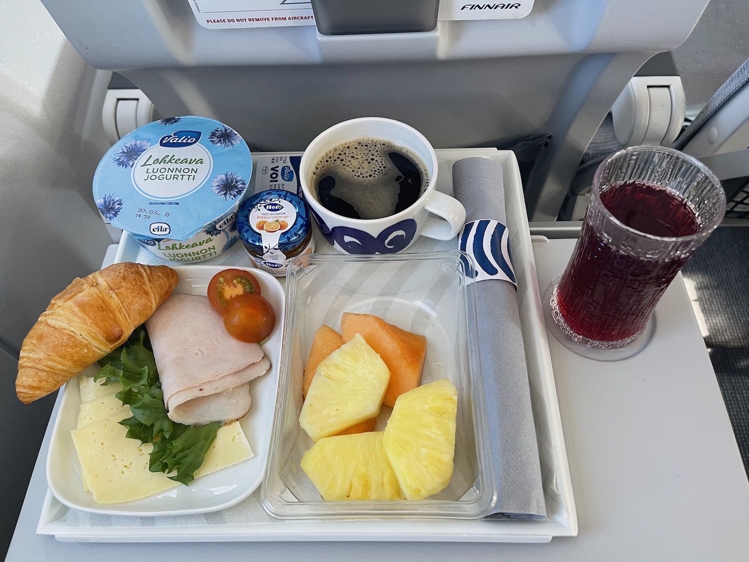 a tray of food and drink on a plane