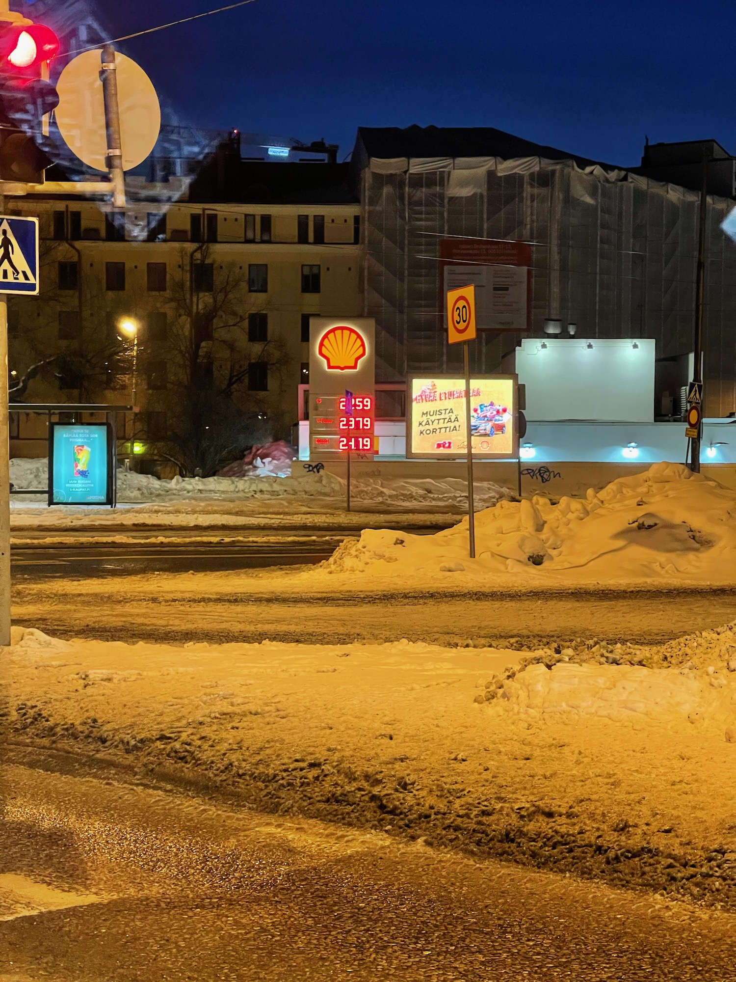 a street with signs and snow on it