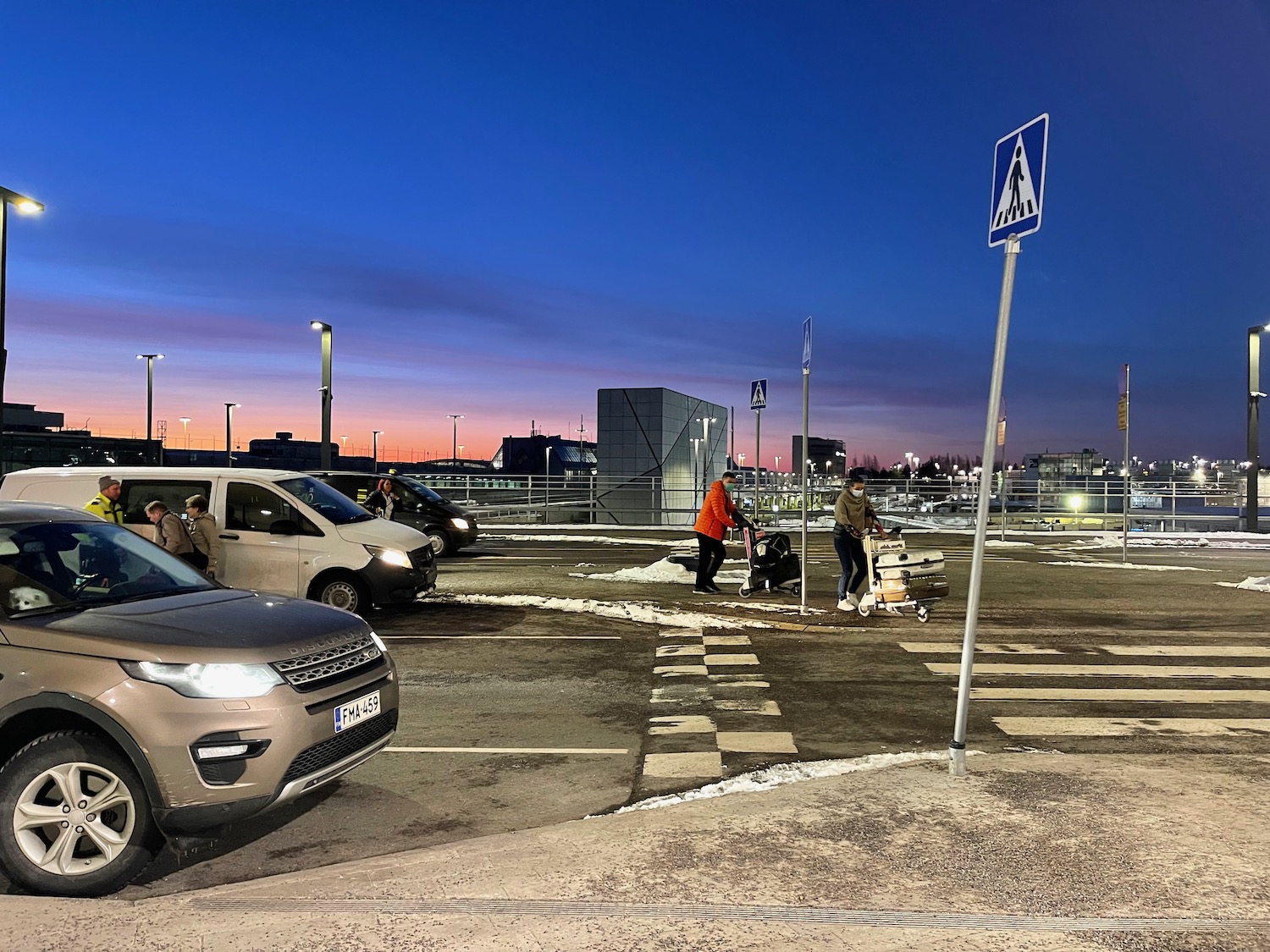 a group of people walking in a parking lot