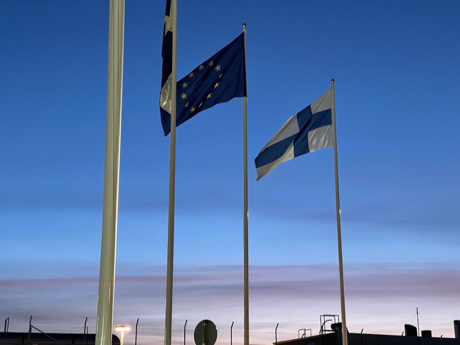 a group of flags on poles