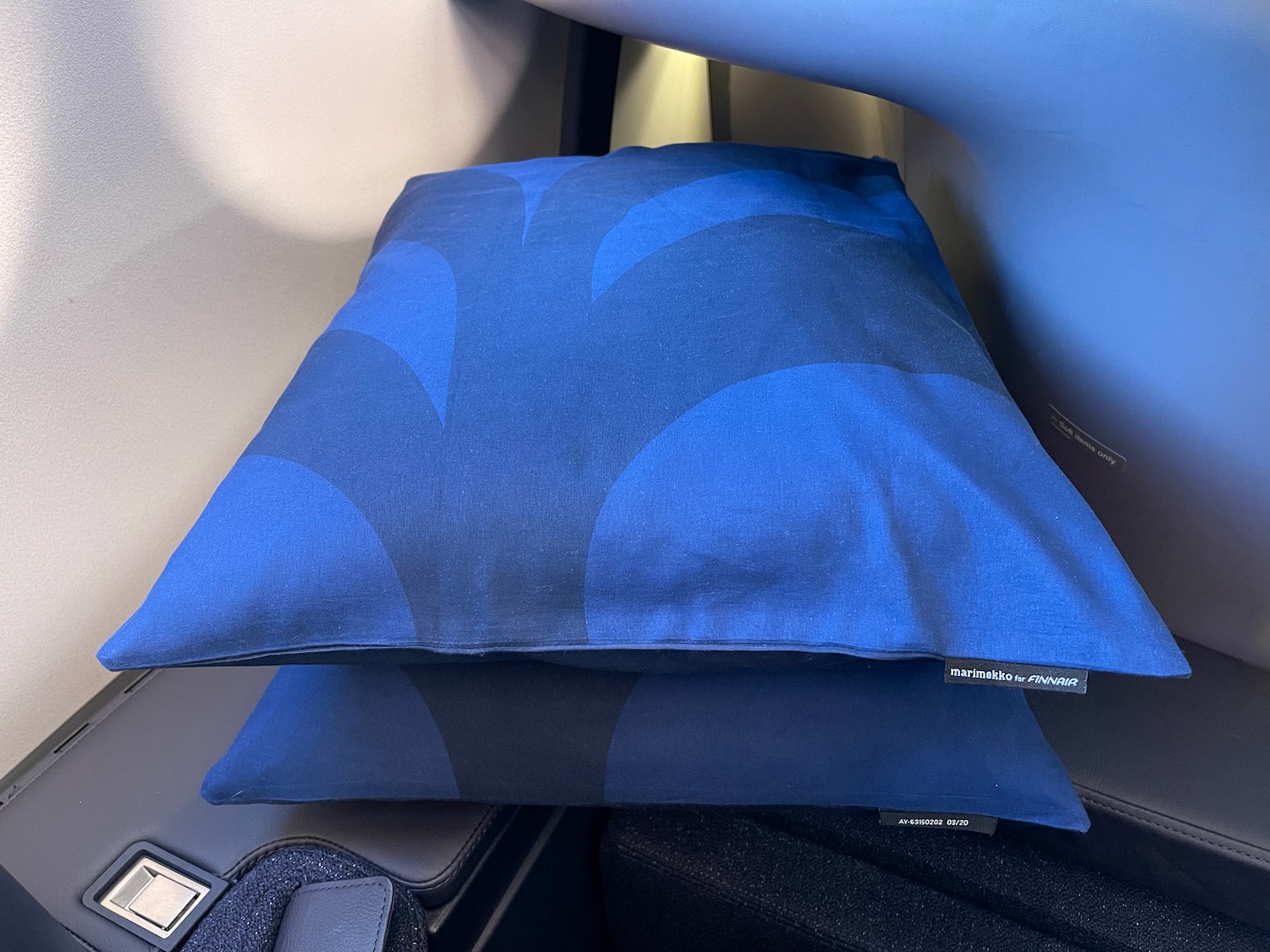 a blue pillow on a chair