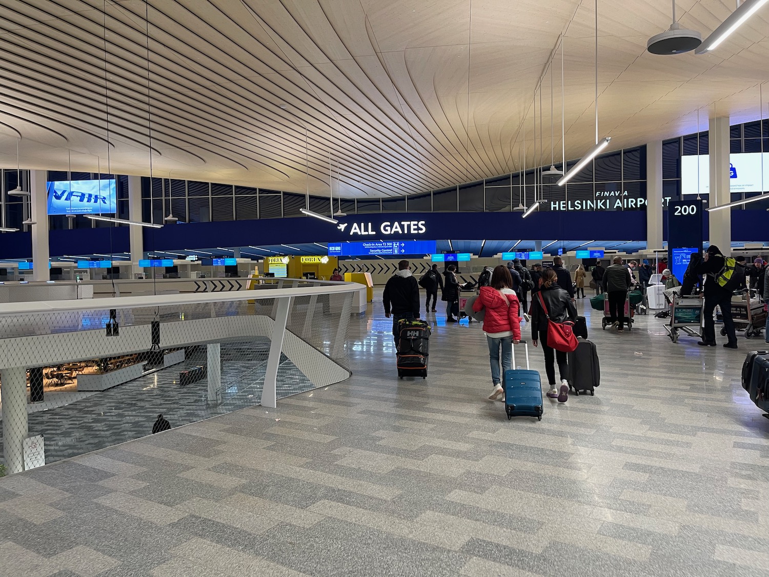 people walking with luggage in an airport